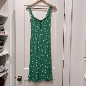 Green floral dress with high slit on left side. Sizing runs small.